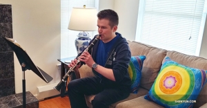 Clarinet player Yevgeniy Reznik practicing some of his solos from previous Shen Yun Symphony Orchestra concert tours. Also, notice his product placement with not one, but two cushion covers from Shen Yun Shop!